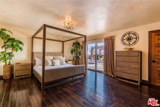 bedroom featuring dark wood-type flooring and access to outside