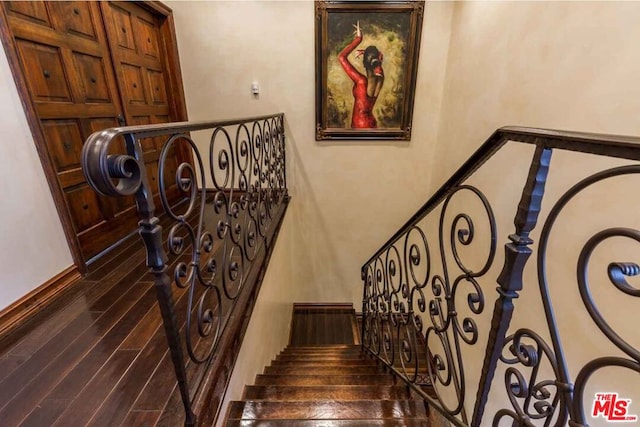 staircase featuring hardwood / wood-style floors