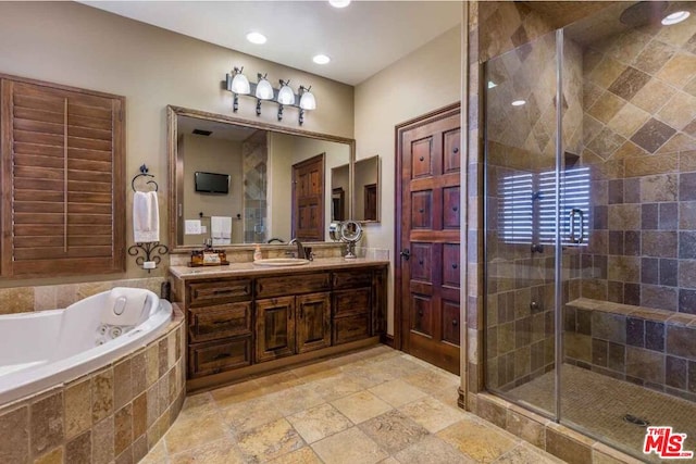 bathroom with shower with separate bathtub and vanity