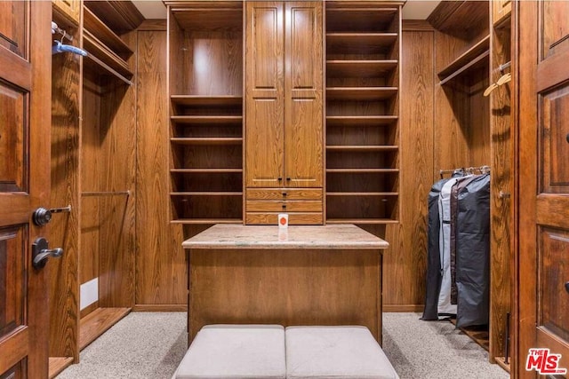 walk in closet featuring light colored carpet