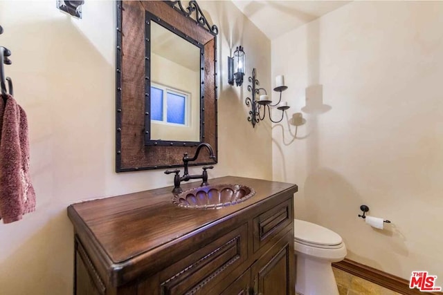 bathroom featuring toilet and vanity