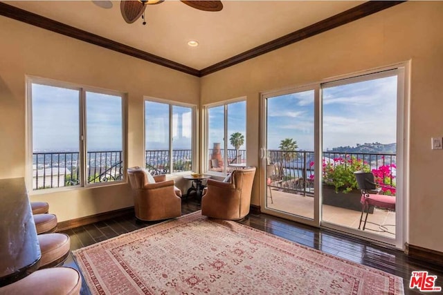 sunroom / solarium featuring a water view, ceiling fan, and a wealth of natural light