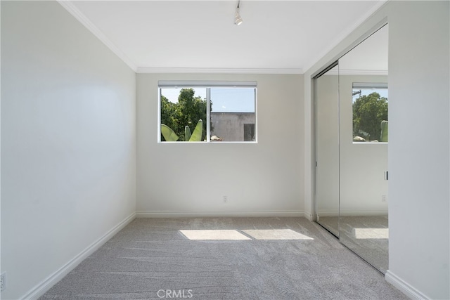 carpeted spare room with crown molding