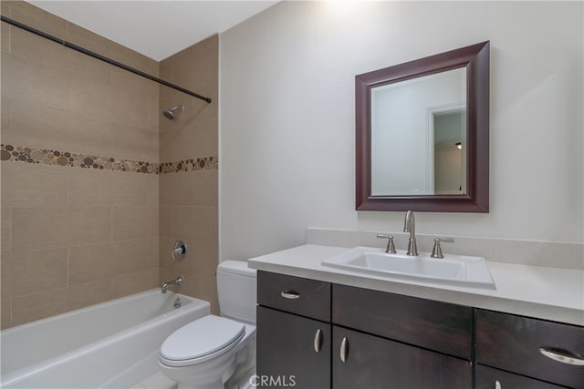 full bathroom featuring toilet, tiled shower / bath combo, and vanity