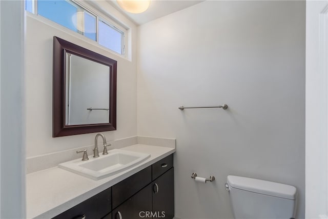 bathroom with toilet and vanity