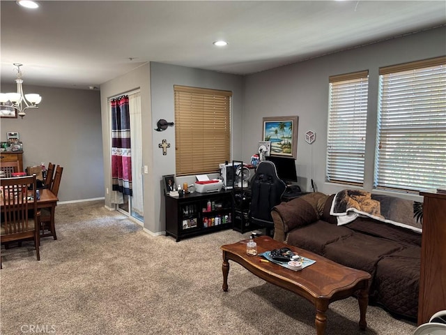 carpeted living room featuring a chandelier