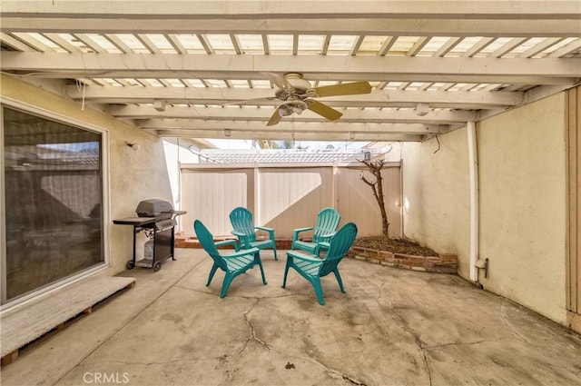 view of patio with ceiling fan, fence, area for grilling, and a pergola