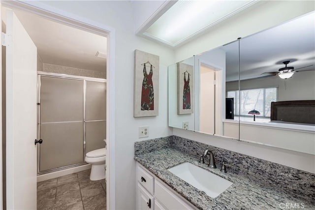 bathroom featuring toilet, ceiling fan, a shower stall, vanity, and tile patterned flooring