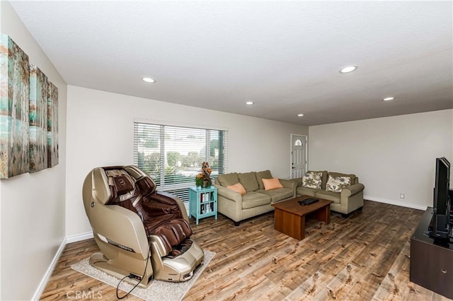 living room featuring recessed lighting, wood finished floors, and baseboards