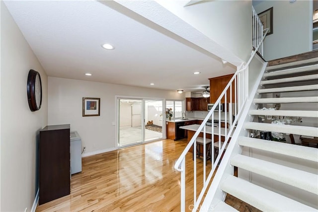 stairway with baseboards, wood finished floors, a ceiling fan, and recessed lighting