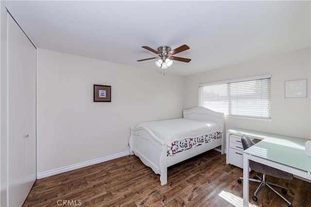 bedroom featuring ceiling fan, baseboards, and wood finished floors