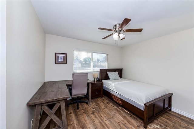 bedroom featuring ceiling fan, baseboards, and wood finished floors