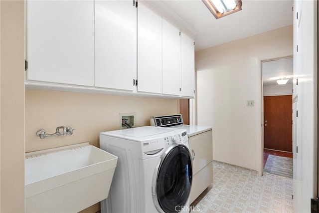 laundry area with cabinets, sink, and washer and dryer