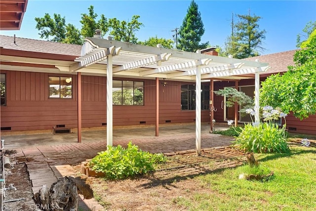 rear view of house featuring a pergola and a patio area