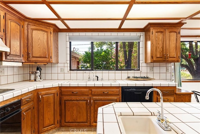 kitchen featuring wall oven, tile counters, tasteful backsplash, dishwasher, and sink