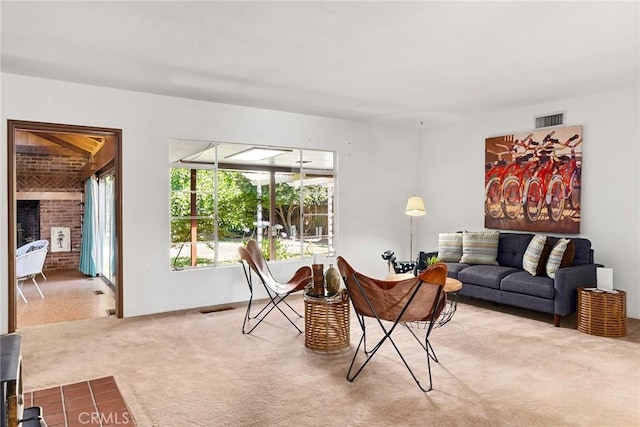 living room featuring carpet flooring and a fireplace