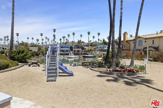 view of jungle gym with a water view