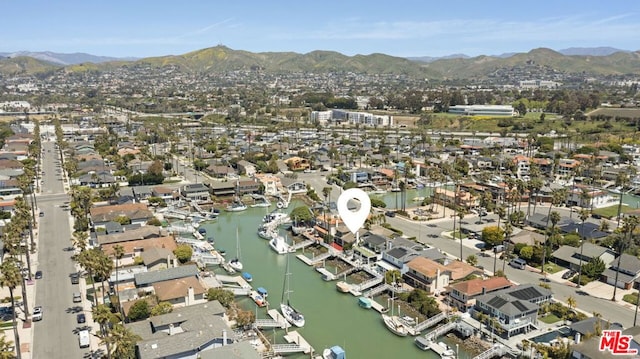 drone / aerial view with a water and mountain view