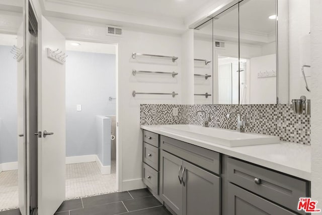 bathroom with walk in shower, vanity, tile patterned floors, decorative backsplash, and ornamental molding