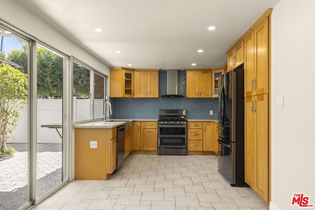 kitchen with sink, black appliances, backsplash, and wall chimney range hood