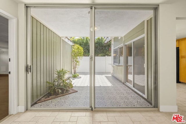 doorway to outside featuring floor to ceiling windows