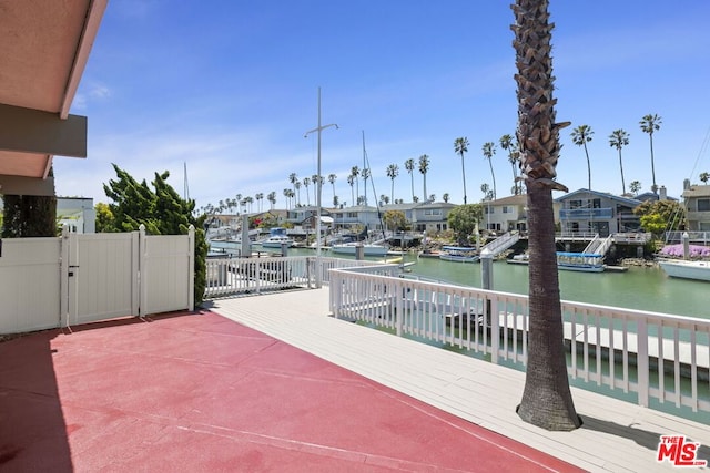 view of patio / terrace with a water view and a dock