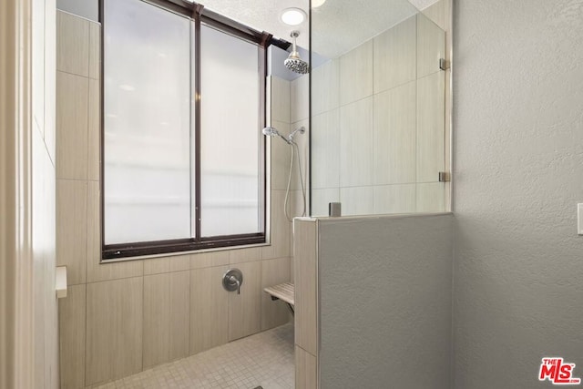 bathroom featuring a tile shower