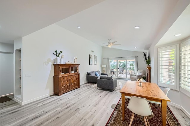 dining room with lofted ceiling, ceiling fan, built in features, and light hardwood / wood-style floors