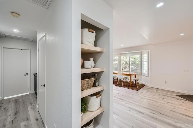 corridor with light hardwood / wood-style flooring