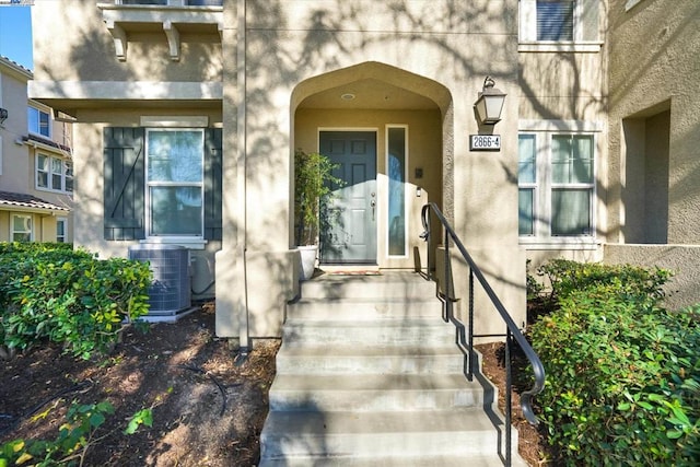 doorway to property featuring cooling unit