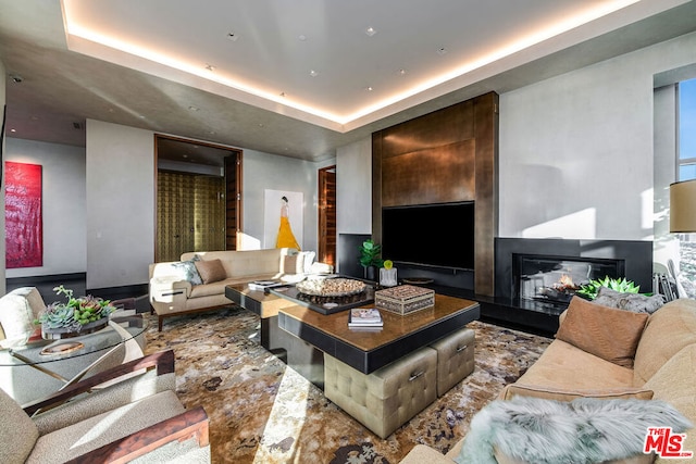 living room with a tray ceiling