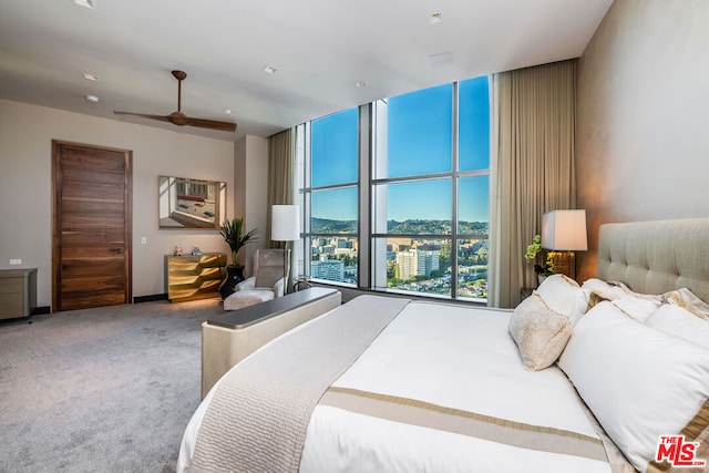 bedroom featuring ceiling fan, carpet, and expansive windows