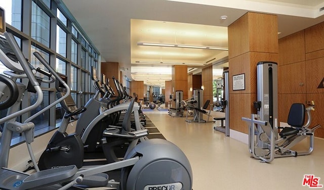 gym featuring wood walls