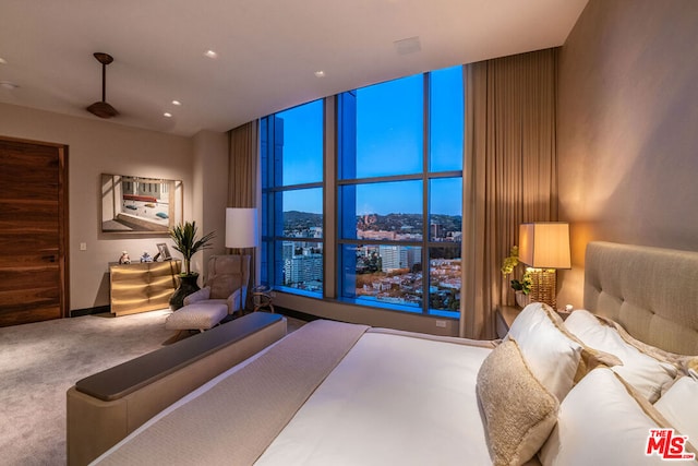 carpeted bedroom featuring floor to ceiling windows