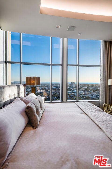 unfurnished bedroom with a wall of windows