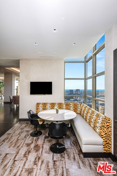 dining space featuring expansive windows and hardwood / wood-style floors