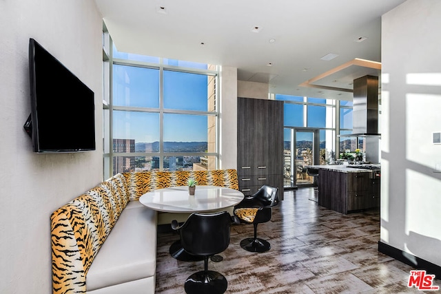 dining area with a wall of windows and breakfast area