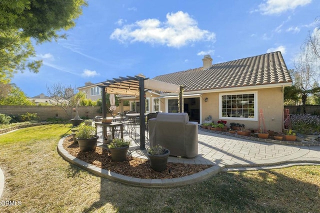 rear view of property featuring a pergola, a patio area, and a yard