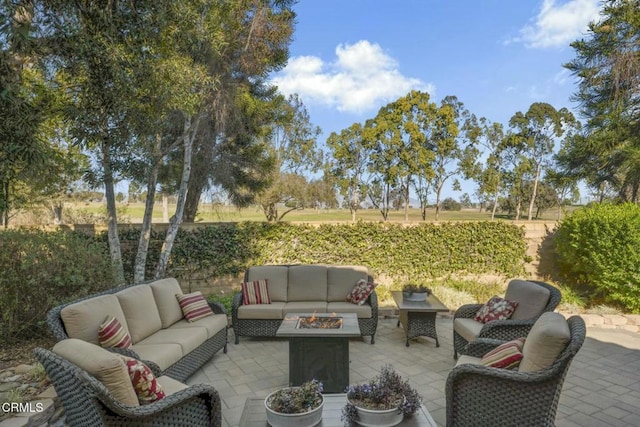 view of patio / terrace with an outdoor living space with a fire pit