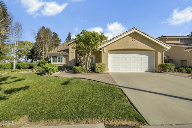 mediterranean / spanish-style home featuring a garage and a front yard