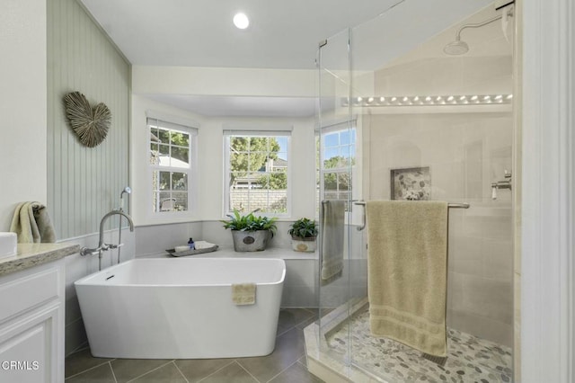 bathroom featuring vanity, independent shower and bath, and tile patterned flooring