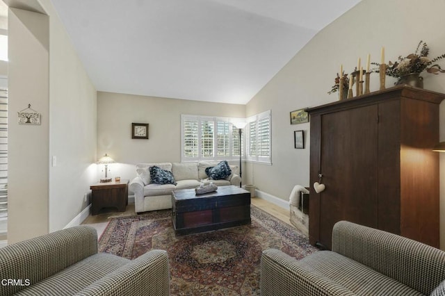 living room with hardwood / wood-style flooring and vaulted ceiling