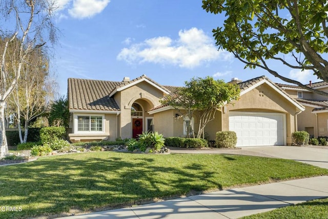 view of front of home with a front lawn and a garage