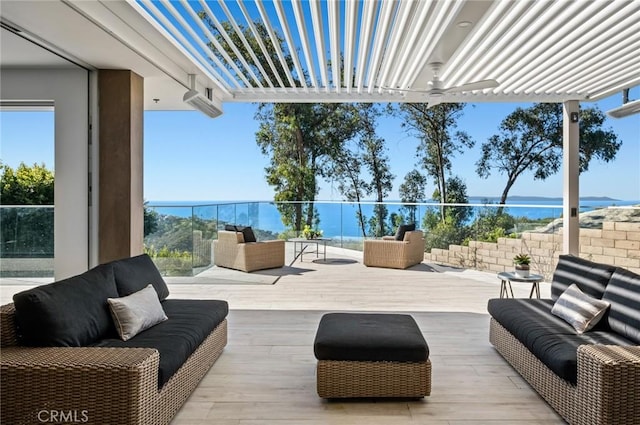 view of patio with a water view, a pergola, and outdoor lounge area