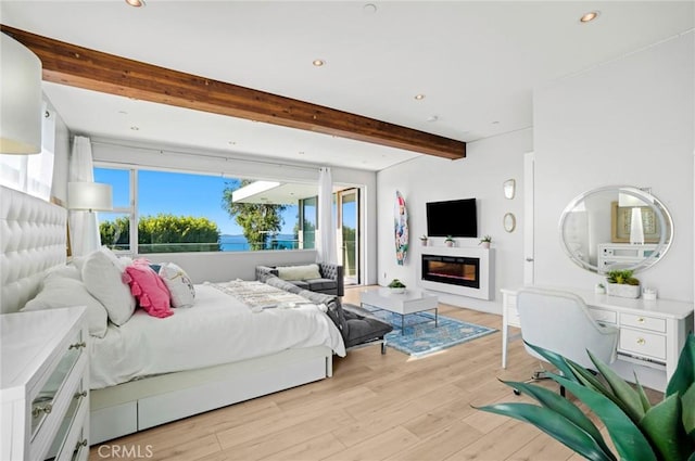 bedroom with beam ceiling, light wood-type flooring, and access to exterior