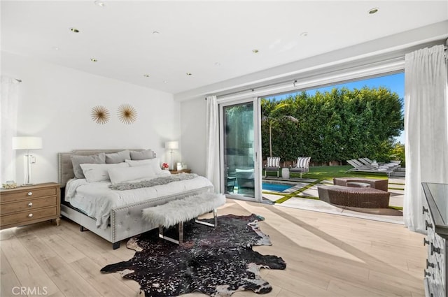 bedroom featuring access to exterior and light hardwood / wood-style flooring