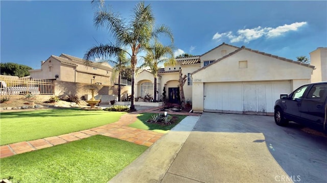 mediterranean / spanish-style home with a front yard and a garage