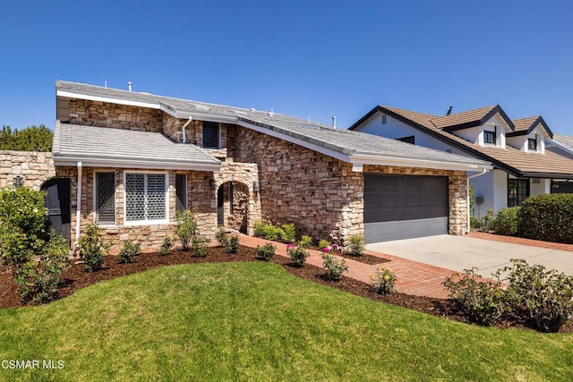 view of front of home featuring a garage and a front lawn