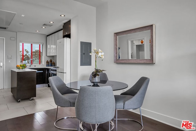 dining room with light tile patterned floors and electric panel