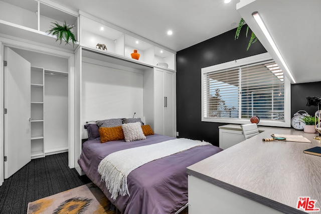 bedroom with a closet and dark carpet